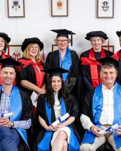 Photograph of staff and students at graduation.